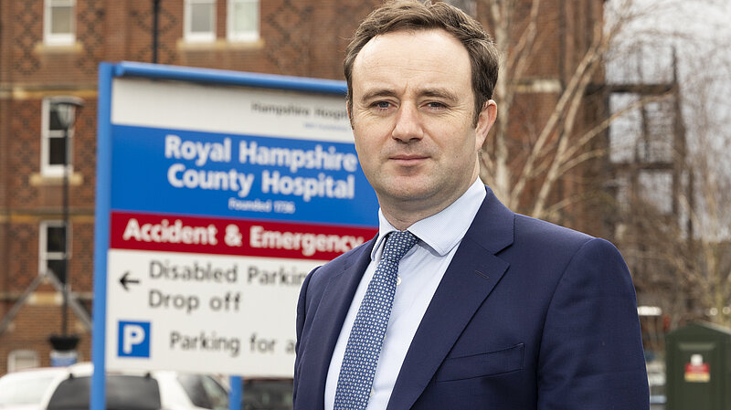 Danny in front of the Royal Hampshire County Hospital sign