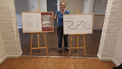 Cllr Kathleen Becker stands with the info board on the Lido