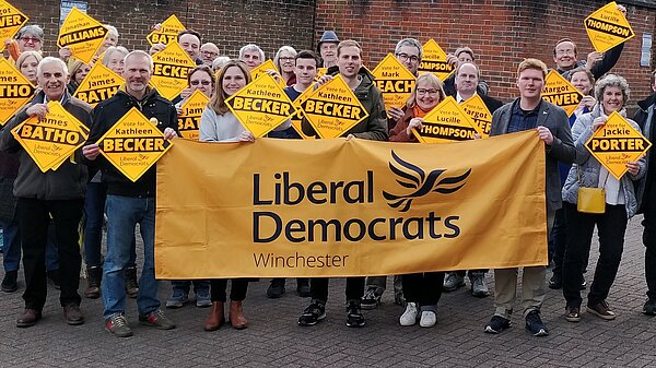 Lib Dem campaigners with Winchester Liberal Democrats banner