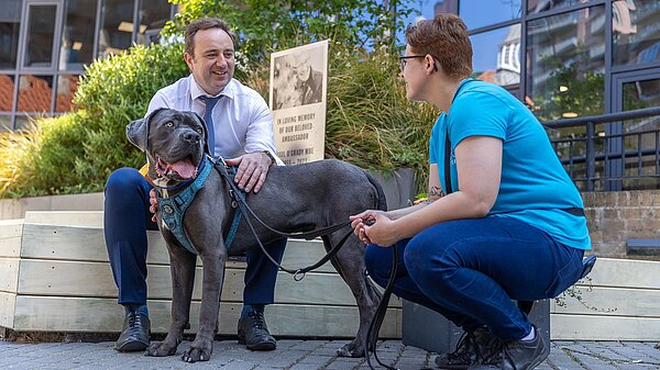 Danny with a dog outside Battersea Home